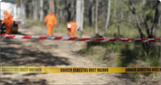 Danger asbestos dust hazard strip with construction workers wearing construction suits behind the marked area