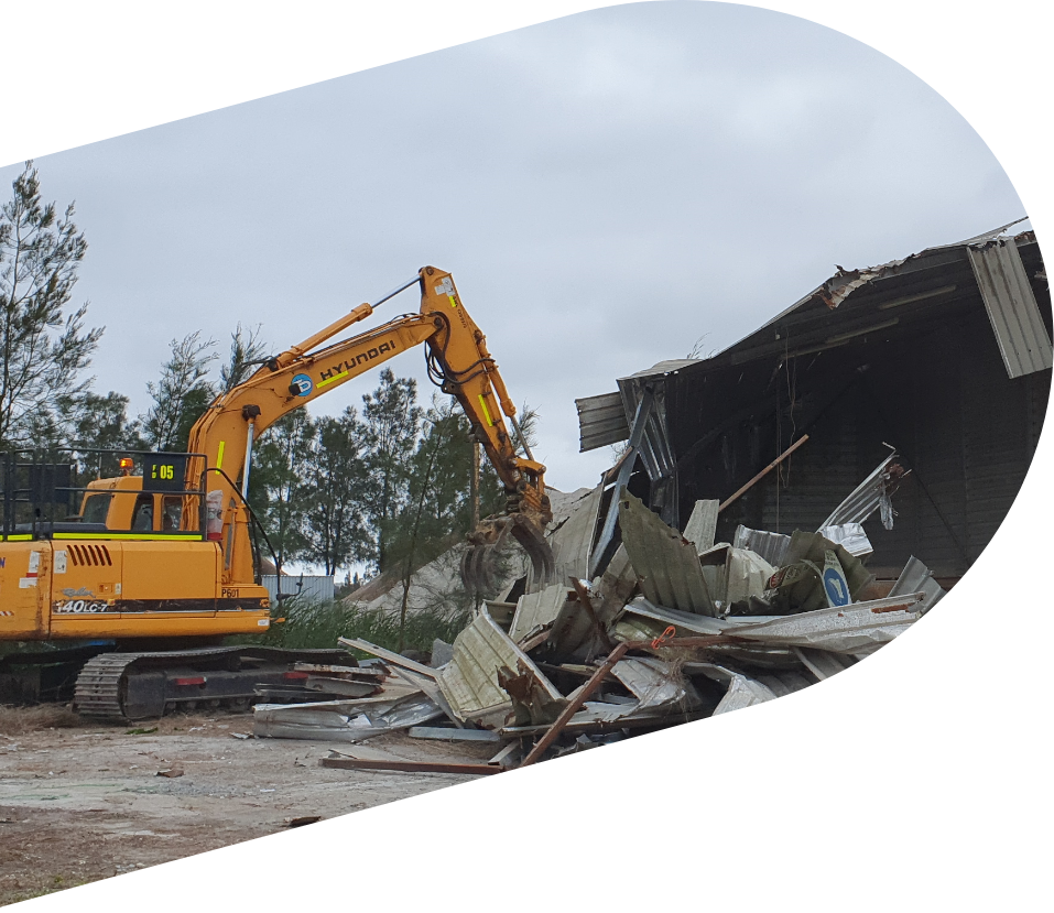 Excavator demolishing old structures