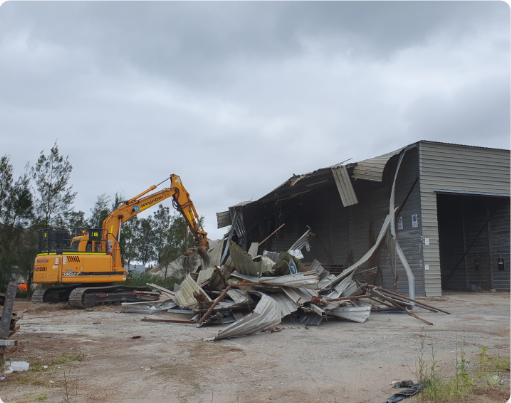 Excavator demolishing old structures