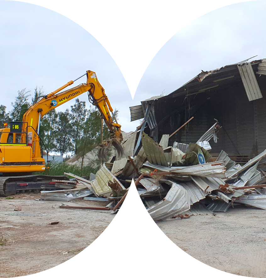 Excavator demolishing old structures